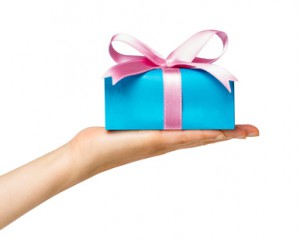 blaues Geschenk mit rosa Schleife auf einer Hand