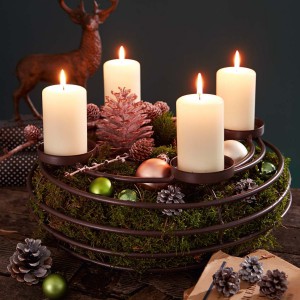 Adventskranzrahmen mit Moosgefüllt und weißen Kerzen drauf